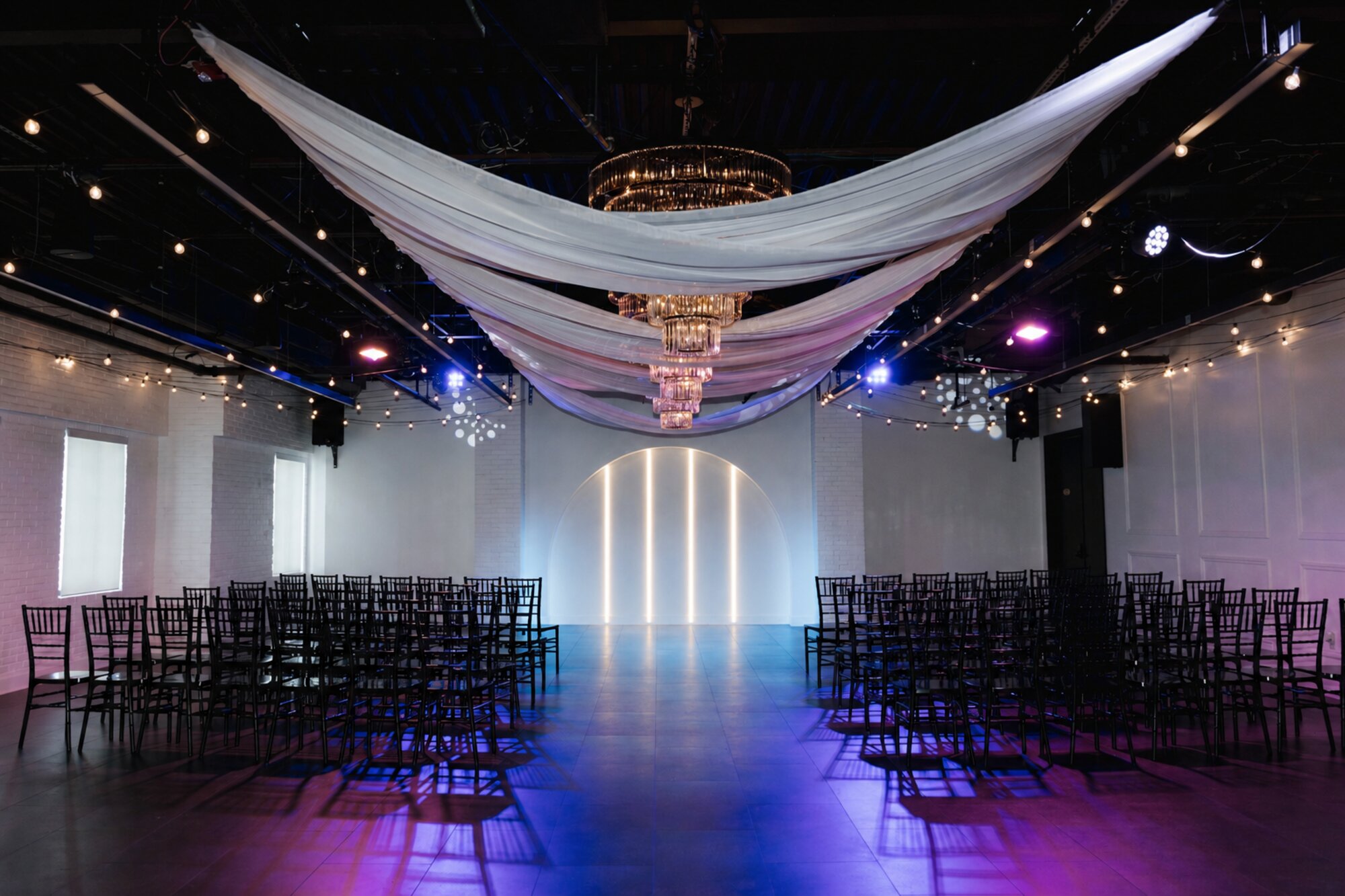 The Trellis 925 flagship venue interior — draped ceiling, chandelier, and dramatic lighting
